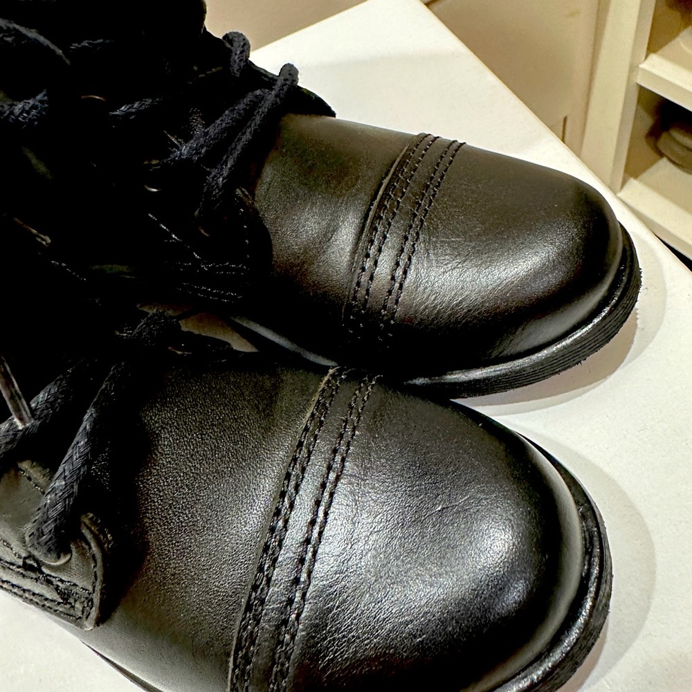 New, tried on, never worn. Black boots. Tie and zip.